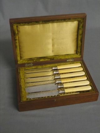 A set of 6 Victorian fruit knives and forks with silver plated blades, contained in a walnut canteen box