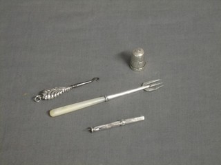 A silver cased tooth pick by S Morden & Co, a miniature silver handled button hook, a silver pickle fork with mother of pearl handle and a silver thimble