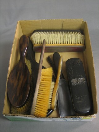 2 ebony backed hand mirrors and a collection of various hair brushes, clothes brushes etc