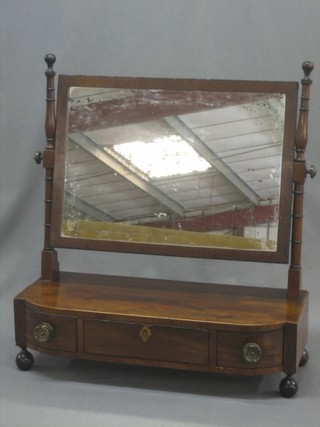 A 19th Century rectangular plate dressing table mirror contained in a mahogany swing frame, the base fitted 1 long drawer flanked by 2 short drawers and raised on bun feet 21"