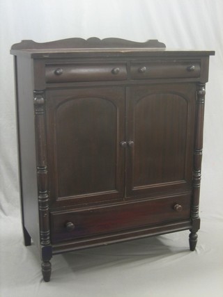 A Victorian mahogany tall boy, fitted 2 drawers, the interior fitted 4 later trays, the base fitted 1 long drawer and raised on turned supports 40"