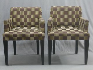 A pair of mahogany framed armchairs upholstered in brown chequered material