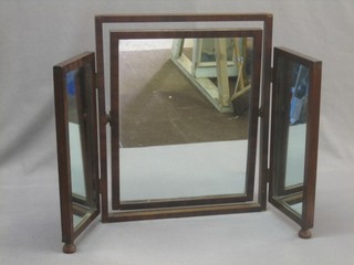 A triple plate dressing table mirror contained in a mahogany swing frame