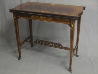 An Edwardian rectangular rosewood card table, raised on turned supports with an H framed stretcher and bobbin turned decoration 34"