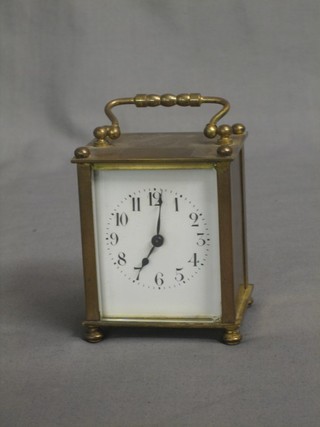 A 19th Century French carriage clock with enamelled dial and Arabic numerals contained in a gilt metal case 3 1/2"