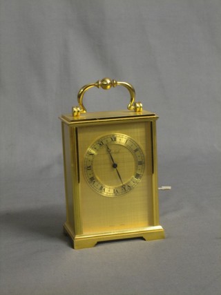 A  Swiss carriage clock contained in a gilt metal case