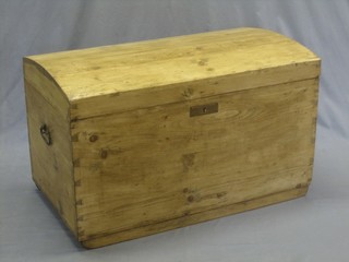 A dome shaped stripped and polished pine trunk with hinged lid and iron drop handles 34"