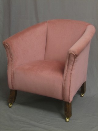 A mahogany framed tub backed chair upholstered in pink material