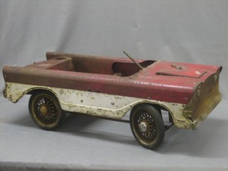 A childs Triang metal framed pedal car in the form of a Triumph Herald? (battered, no steering wheel) 32"