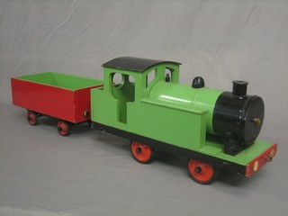 A childs wooden model locomotive and tender