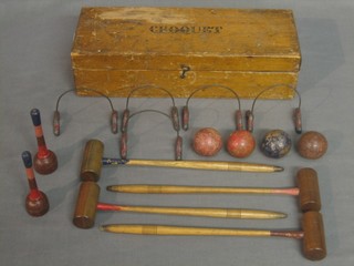 A 19th Century table top croquet set comprising 4 mallets, 5 hoops, 4 balls and 2 sticks, boxed