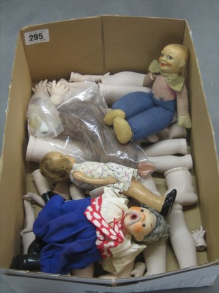 3 small costume dolls and a collection of biscuit porcelain dolls legs and arms