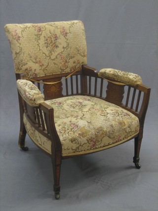 An Edwardian inlaid mahogany armchair with stick back decoration raised on square tapering supports