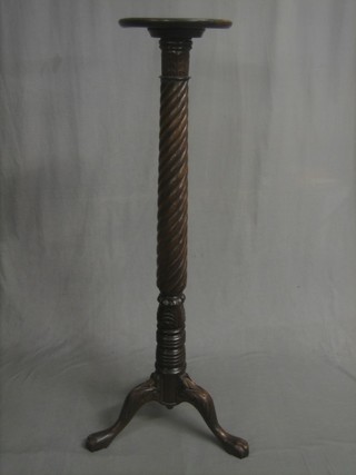 A Victorian turned mahogany bed post torchere raised on pillar and tripod supports