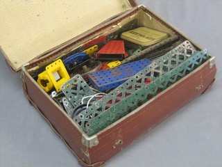 A collection of green and blue Meccano contained in a small attache case