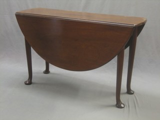 A Georgian mahogany oval drop flap dining table, raised on club supports 46"