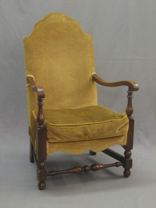 A Queen Anne style beech framed open arm chair upholstered in yellow material and raised on turned supports