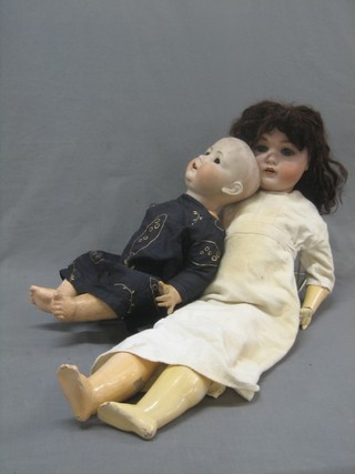 A German porcelain headed doll with open and shutting eyes, open mouth with 2 teeth, the head inscribed A & Co ? 76 Germany with articulated body together with 1 other with open eyes, open mouth with 2 teeth, head incised BXOP 585 13 German