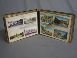 An Oriental lacquered album of coloured postcards