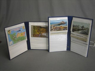 2 blue albums of coloured postcards of seaside resorts etc