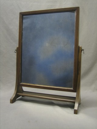 A 19th Century rectangular plate dressing table mirror contained in a walnut swing frame 17"