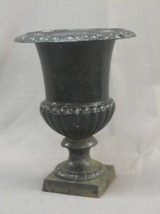 A Victorian style trumpet shaped garden urn with egg and dart border and lobed shaped body, raised on a square foot 12"