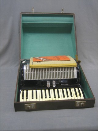 A Frisco accordion with 48 buttons complete with fibre carrying case