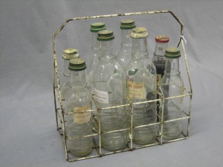 A wire 8 bottle cage containing various glass motor oil bottles
