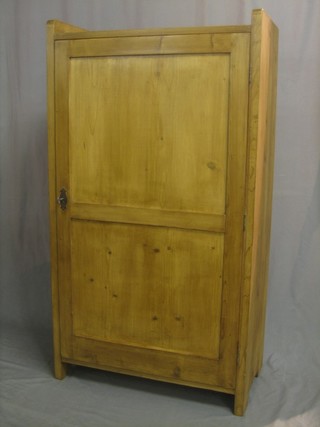A Continental stripped and polished pine cabinet with three-quarter gallery, the interior fitted shelves enclosed by a panelled door 29"