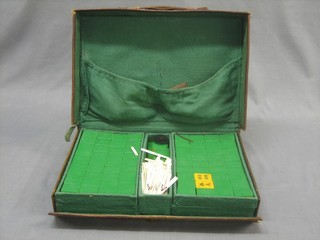 A plastic Mah Jong set contained in a leather carrying case