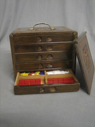 A bamboo and plastic Mah Jong set contained in a carved wooden carrying case