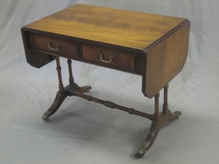A Georgian style miniature mahogany sofa table fitted 2 drawers, raised on turned supports 25"