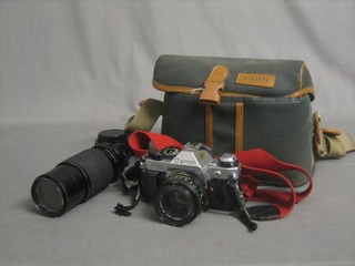 A Canon AE-1 camera, 3 various lenses and a flash unit