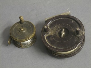 A brass centre pin fishing reel 2 1/2" together with an Alcock Aerialite brown Bakelite centre pin fishing reel 4"