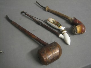 A large wooden pipe, 1 other pipe and a porcelain pipe