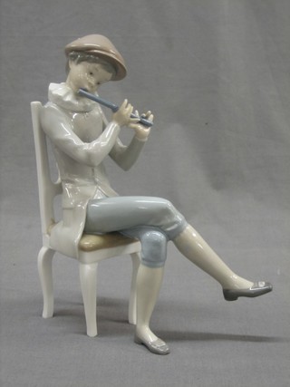 A Lladro figure of a seated boy playing a flute no.4877 9" (f and r)