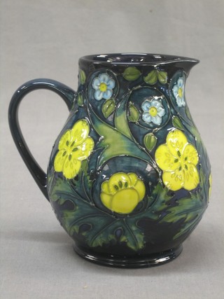 A Moorcroft pottery jug with floral Buttercup and Forget-me-not  decoration, base impressed Moorcroft with signature and marked 14794 WM 5"