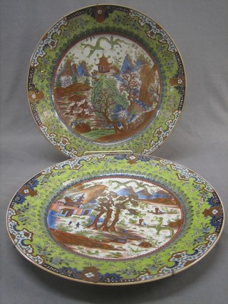A handsome pair of 18th/19th Century Oriental chargers decorated landscape scenes, the reverse with seal mark (heavily f and r) 18"