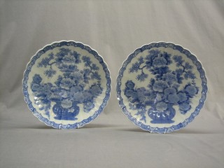 A pair of Japanese blue and white porcelain bowls decorated a vase of flowers with scalloped border, the reverse with seal mark 12"