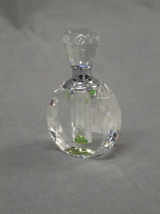 An oval faceted glass scent bottle and stopper 4"