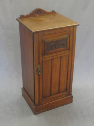 A Victorian carved walnut pot cupboard enclosed by panelled door 15"