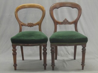 A harlequin set of 9 mahogany balloon back dining chairs with carved mid rails and upholstered seats, raised on turned supports