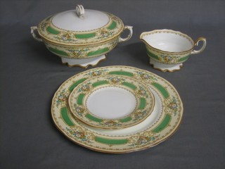 A 29 piece Royal Crown Stafford dinner service comprising 2 10" circular twin handled tureens and covers (bases f), 3 graduated oval meat plates (1f), 6 11" dinner plates (3f), 6 9 1/2" side plates (2f), and 12 7" tea plates (2f) and a pale green cup and saucer 