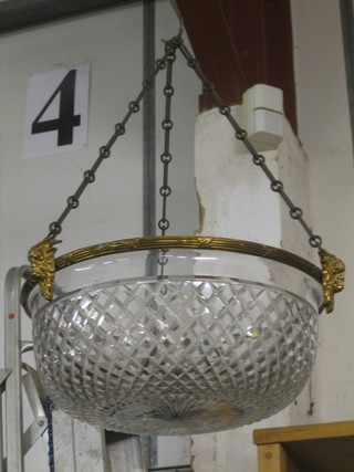 A circular cut glass light fitting with gilt metal mounts and rams mask decoration