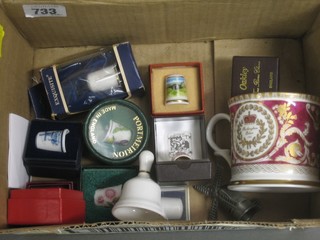 A small collection of thimbles and a Buckingham Palace souvenir mug