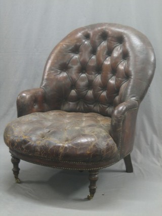 A 19th Century mahogany framed armchair upholstered in brown buttoned back leather