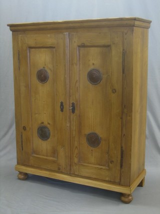 A Continental stripped and polished pine meat cabinet, the interior fitted shelves enclosed by panelled doors 39"