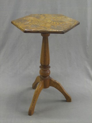 An octagonal Eastern carved hardwood wine table, raised on pillar and tripod supports 20"