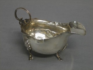 An Edwardian silver cream jug with C scroll handle, Chester 1904 2 ozs (some tears)