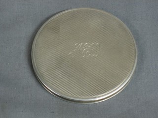A circular engraved silver compact with engine turned decoration 3"